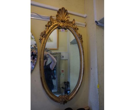 A reproduction giltwood framed oval wall mirror,&nbsp;92 x 43.5cm. 