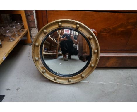 A small reproduction gilt framed convex wall mirror,&nbsp;39.5cm diameter.&nbsp; 