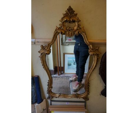 A reproduction giltwood framed wall mirror,&nbsp;86 x 50.5cm.&nbsp; 