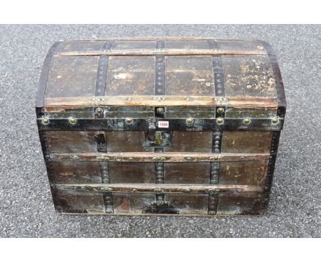 An antique brass studded dome topped trunk.&nbsp; 