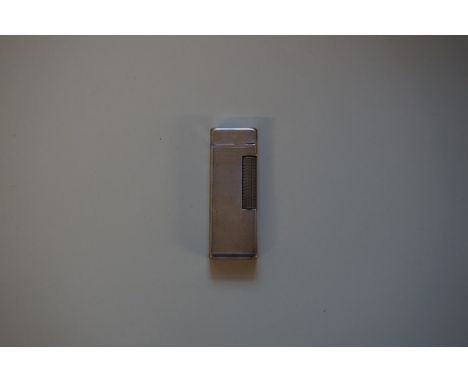A Dunhill engine turned lighter, 6.5cm high. 
