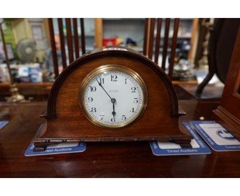A 1920s mahogany dome top mantel timepiece,&nbsp;with enamel dial, 25.5cm wide.&nbsp; 
