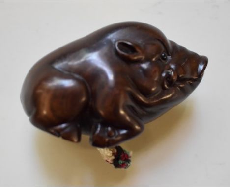 A Japanese carved wood boar netsuke, signed on inset tablet. 