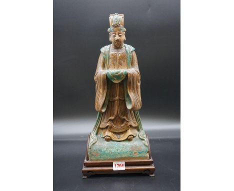 A Chinese glazed figural roof ridge tile,&nbsp;Ming, 39cm high, on fitted wood stand.&nbsp; 