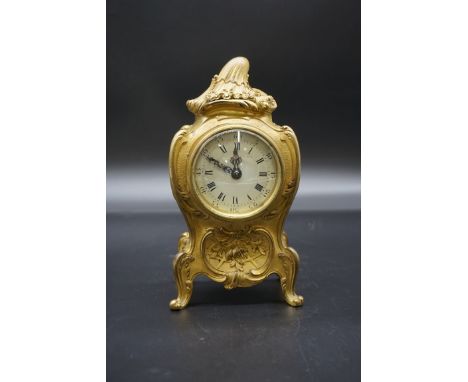 A Louis XV style cast brass cased mantel timepiece, in the Rococo style, 20cm high.&nbsp; 