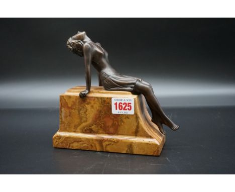 An Art Deco style bronze and marble reclining figure,&nbsp;17cm high.&nbsp; 