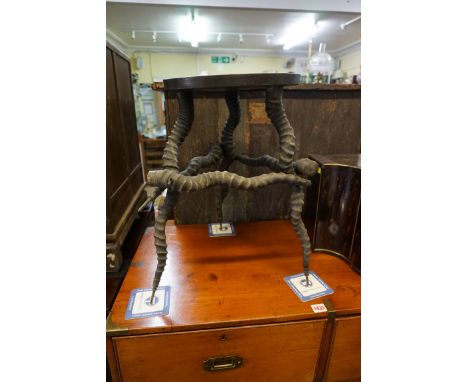 Taxidermy:&nbsp;an antler tripod stool or small table, with ebonized top, 49cm high.&nbsp; 