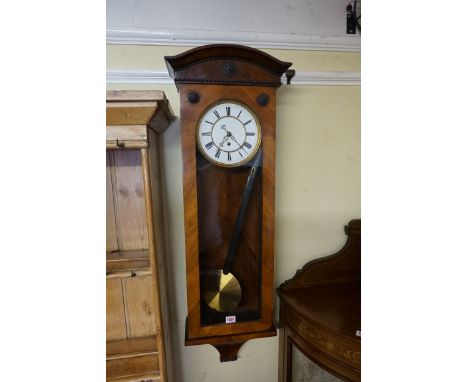 A late 19th/early 20th century walnut Vienna style wall clock,&nbsp;with enamel dial and weight driven movement. 