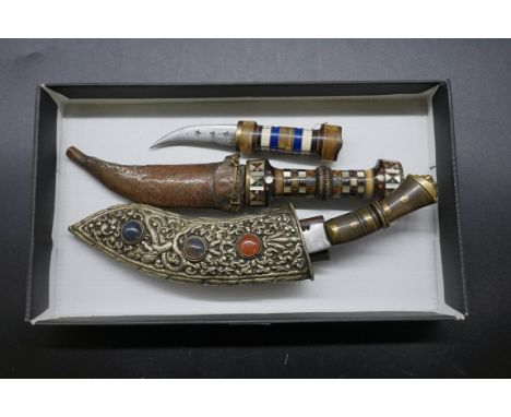 A small kukri and scabbard;&nbsp;together with two other eastern knives.&nbsp; 