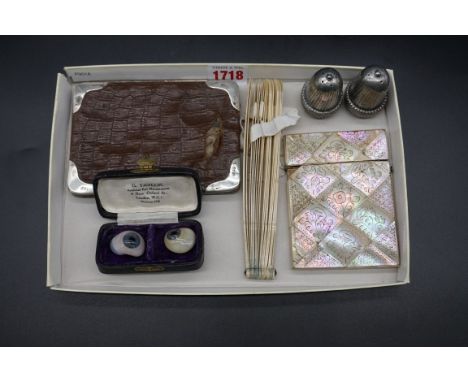 A mixed lot,&nbsp;comprising: two glass false eyes; a pair of electroplated novelty acorn pepperettes; a silver mounted leath