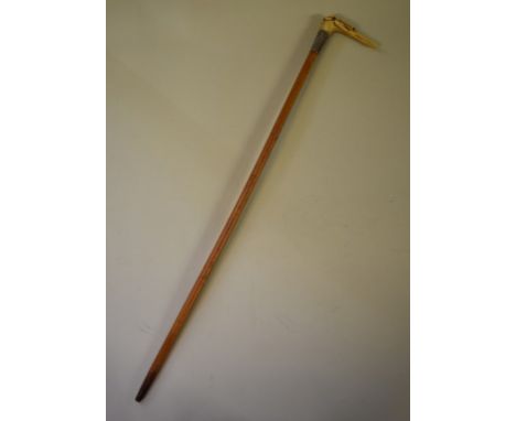 A short swagger stick,&nbsp;the antler handle carved in the form of a hound's head, with glass inset eyes, total length 47cm 