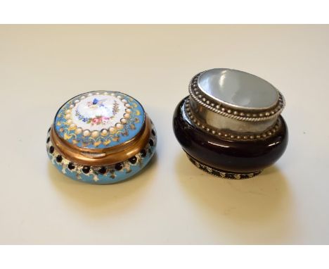 An antique continental enamel pill box, the hinged lid revealing a gilt metal interior, 6cm diameter; together with another a
