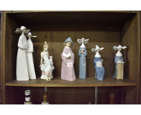 Four Lladro nuns, largest 33cm; together with another Lladro figure; and a Nao figure. (6) 