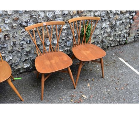 A pair of vintage blonde Ercol candlestick chairs, model 376. 