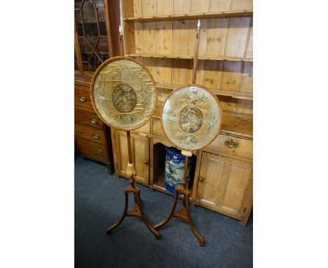 A pair of late 18th century mahogany and line inlaid tripod pole screens,&nbsp;each with rise and fall oval screen incorporat