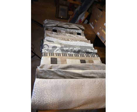 Bolts and offcuts of upholstery material, assorted fabrics, patterns and lengths - mainly silver and gold