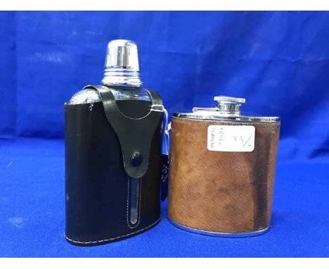 FOUR HIP FLASKS to include a black glass hip flask with drinking cup, black and white stainless steel hip flask and two other