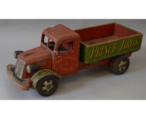 A large scale wooden lorry, marked 'John & Geraint 5 Directors' to cab and 'Prince Bros.' to side, length approx. 77 cm.