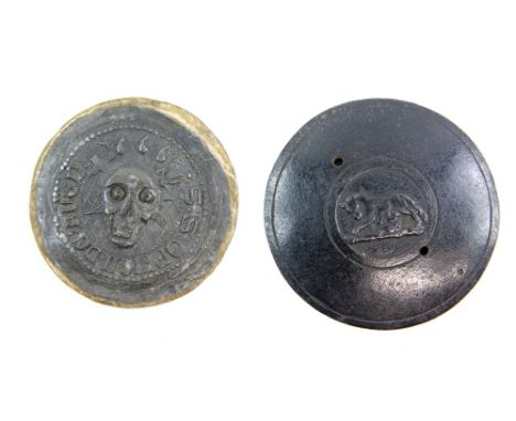 Two cast metal embossed discs, possibly a seal for attaching to a pilgrims flask, one relief moulded with skull and cross and