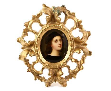 Late 19th/early 20th century oval portrait miniature depicting a young man with brown and a black hat, on porcelain, in a car