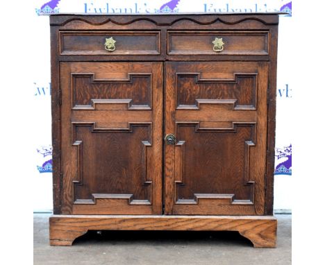 17th century style oak side cupboard with two short drawers above two geometric moulded panelled cupboards on bracket feet.  