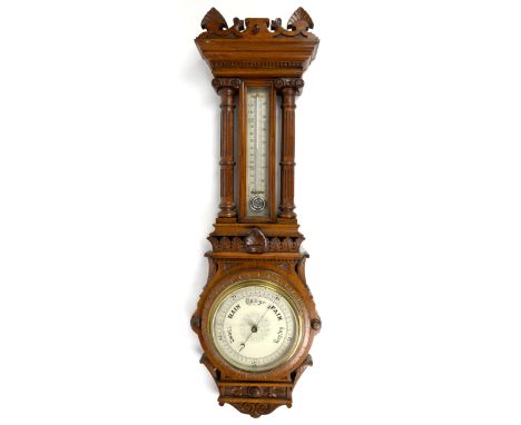 Late 19th / early 20th century oak barometer, with silvered thermometer to neck, crack to glass on barometer, the case with f