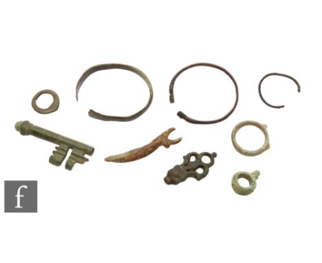 Celtic and Roman - A bronze woad grinder, length 6.5cm, a bronze knife handle of triform form, width 5cm, two bronze bracelet