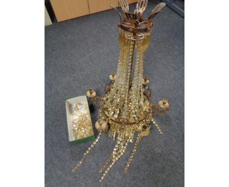 An antique metal six way light fitting with glass drops 