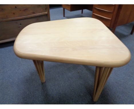 A contemporary light wood occasional table 