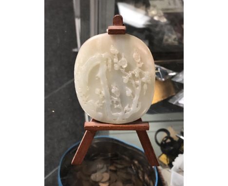 A carved jade roundel on later stand 
