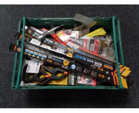 A crate of new tools, bow saw blades, brick hammers, plastic clamps 