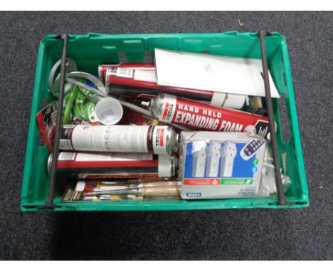 A crate of new tools, chisel set, expanding foam, remote control socket set, bungee cords 