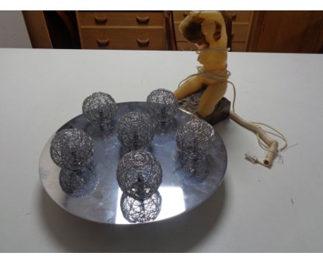 A retro plastic light fitting  of a female nude together with a contemporary chrome light 