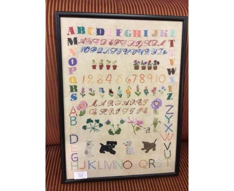 A mid 20thc sampler with Clover, Thistle, Rose and Leek (46cm x 33cm)