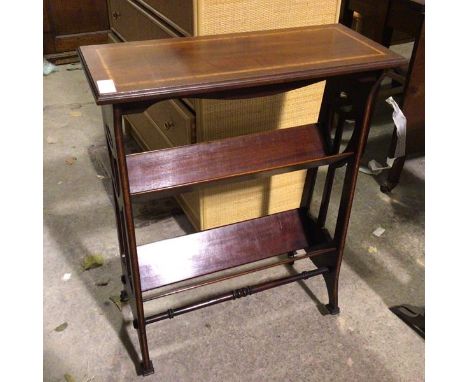 An Edwardian mahogany and boxwood inlaid book trough with rectangular top above two troughs with Art Nouveau inspired piercin