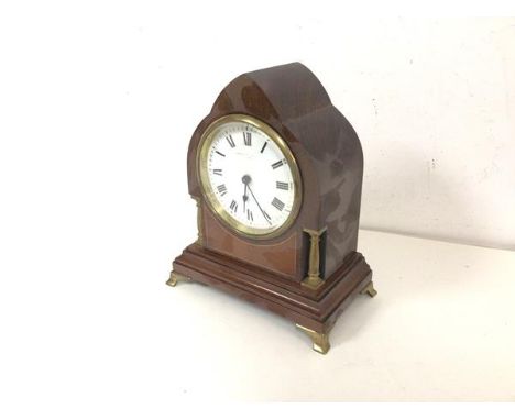 An Edwardian mantel clock of architectural form with roman numerals, on gilt metal bracket feet (19cm x 16cm x 10cm)