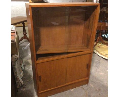 A mid century teak side cabinet, with two sliding glass doors, the interior fitted single adjustable shelf, the base fitted t