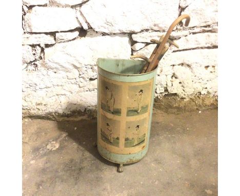 An Edwardian stick stand, in metal painted eggshell blue with decoupage application showing cricketers, on paw feet (one lack