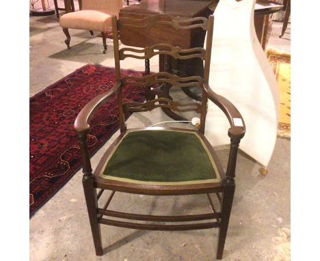 A 1930s/40s Georgian style mahogany open armchair with pierced ladder back, with padded upholstered seat, on straight taperin