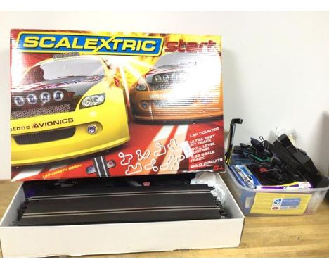 A Scalextric toy racing car set, includes tracks, cars, controllers, in original box along with extra parts (box: 12cm x 65cm