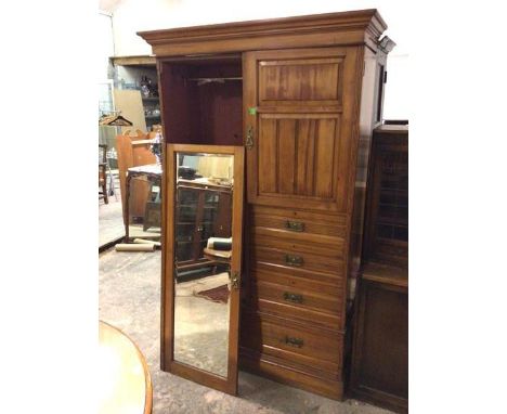 A late 19thc/early 20thc birch wardrobe with a mirror door, the interior with hanging space, with single door enclosing an in