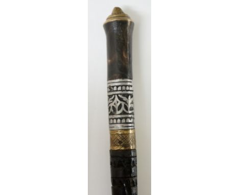 A swordstick, brass pommel above horn? and cast white metal handle, crosshatched brass collar, the ebonised shaft rudimentari