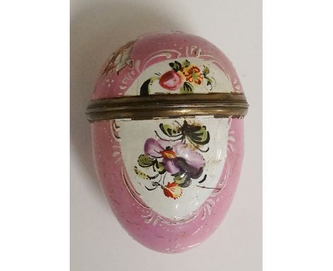 A South Staffordshire pink enamel egg shaped pill box the back and front with white panels decorated with flowers and leafage