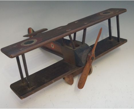 A vintage hand painted wooden model bi-plane with wooden propeller and wheels, 40cm wide, 36cm long, Circa 1950