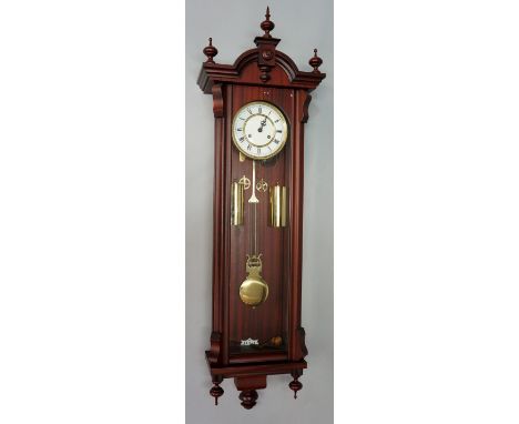 A reproduction mahogany cased Vienna wall clock of conventional form with ball and spire finials the white enamel dial with R