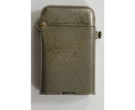 A Thorens cigarette lighter with engine turned white metal case, push button release, the strike wheel inscribed Turn Screw R