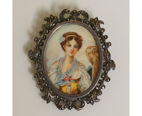 An oval half length portrait miniature of a young girl standing before a pillar, watercolour on ivory, pierced marcasite set 