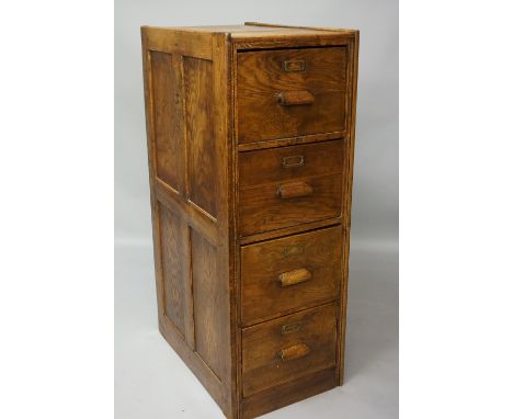 An oak four drawer filing cabinet with moulded frame the drawers with wooden handles and applied brass label holders, each dr