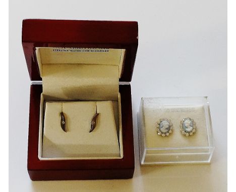 A pair of Hot Diamonds sterling silver and diamond scroll earrings, each 1cm long centred on a small diamond chip; a pair of 