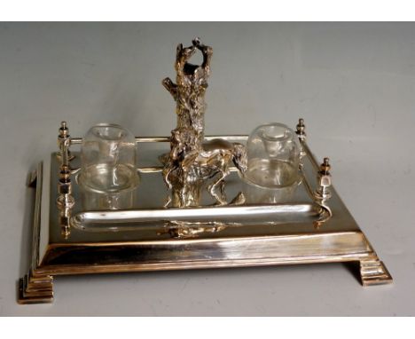 A 20th Century plated double inkwell in the form of a pony prancing before a tree trunk, single rail fence behind, two clear 